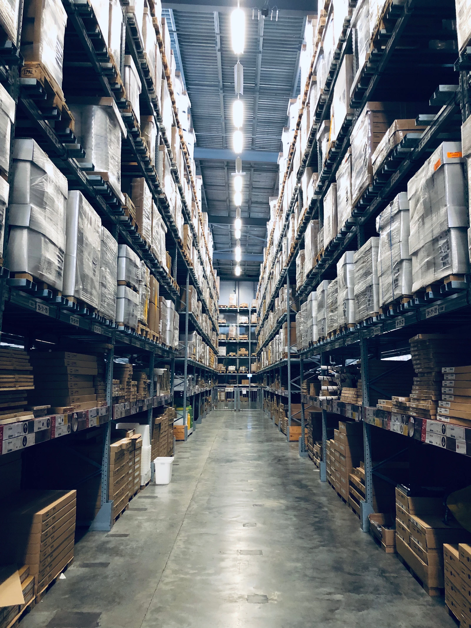 Long warehouse aisle between tall pallet racking
